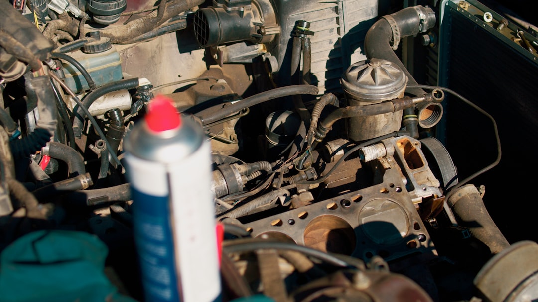 a-close-up-of-a-car-engine-with-a-tube-of-glue-vpu0vrhf3im